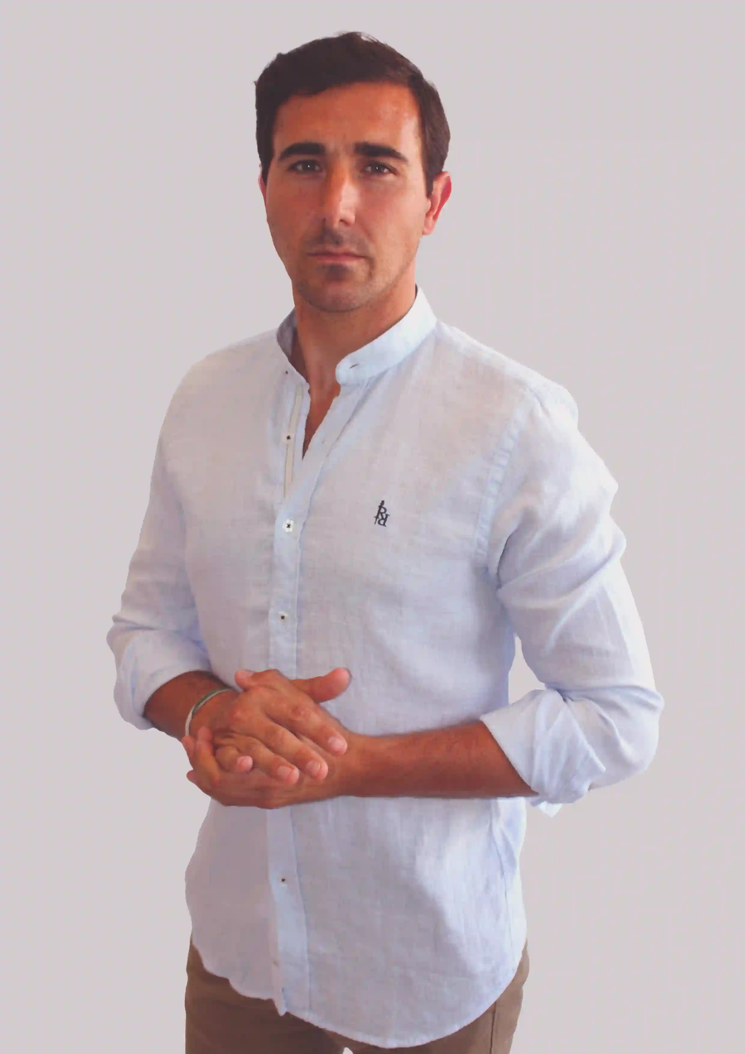 Light blue linen shirt with dark blue embroidered logo.