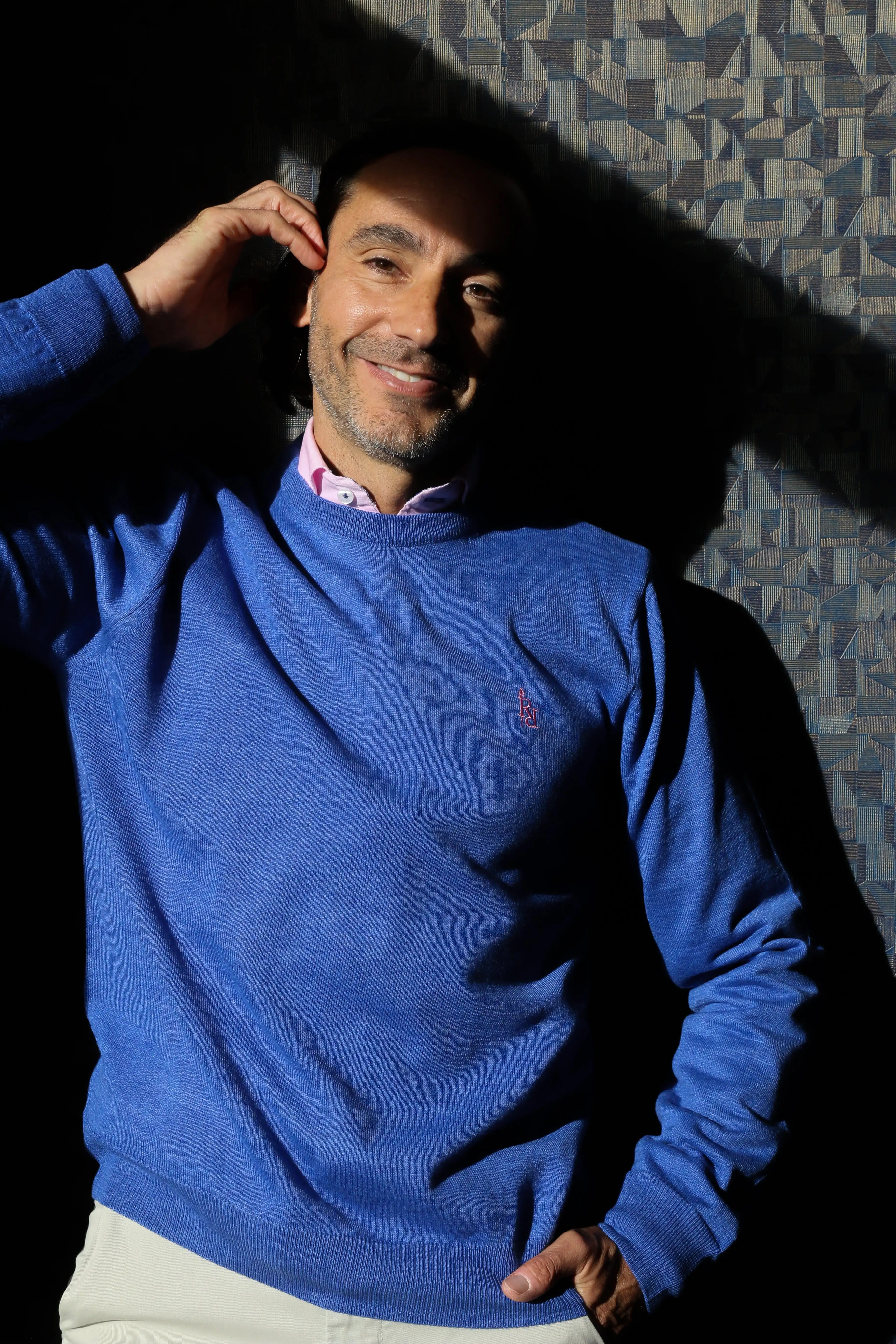 Plain blue crew neck sweater with light pink embroidered logo. - Image 2