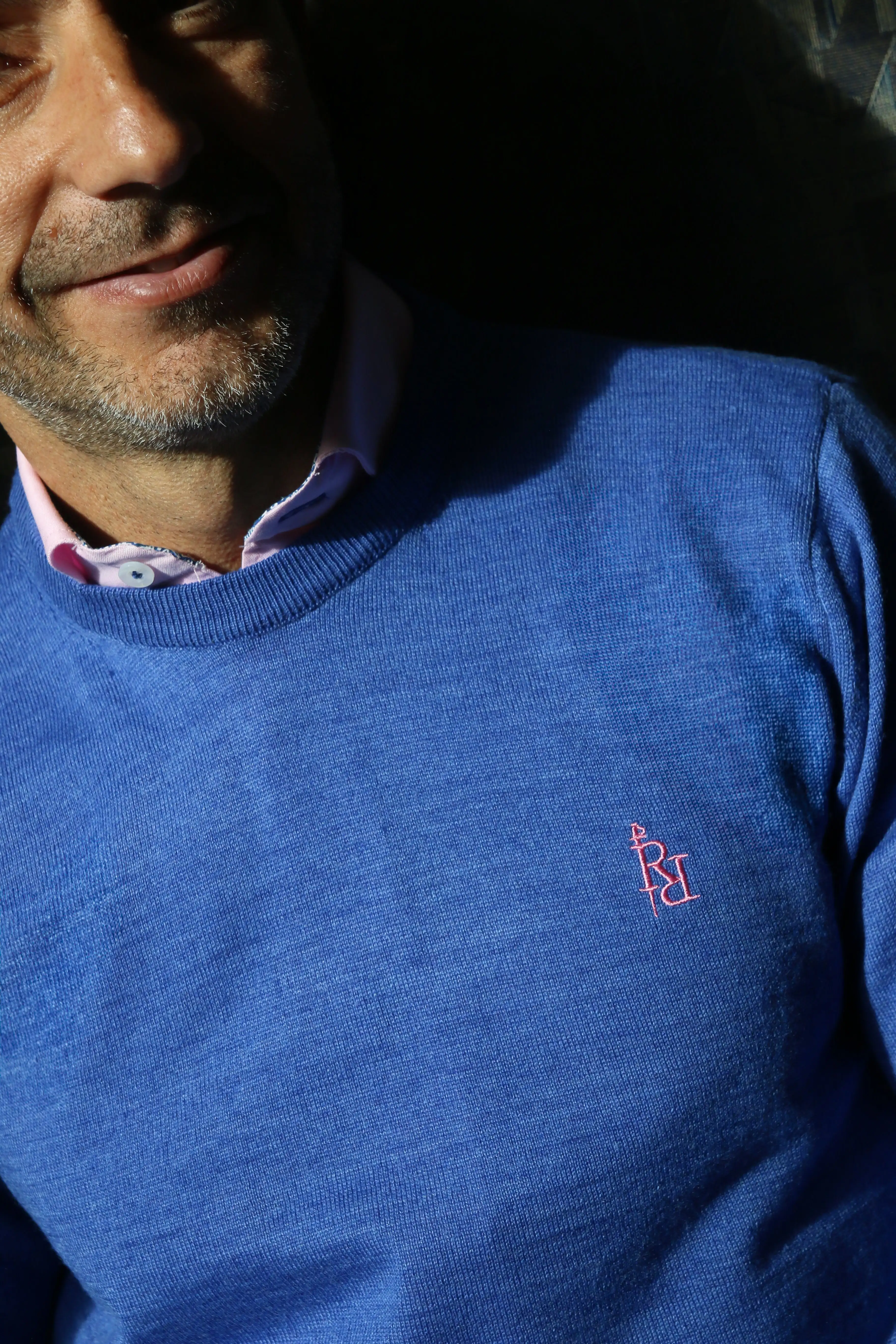 Plain blue crew neck sweater with light pink embroidered logo. - Image 3