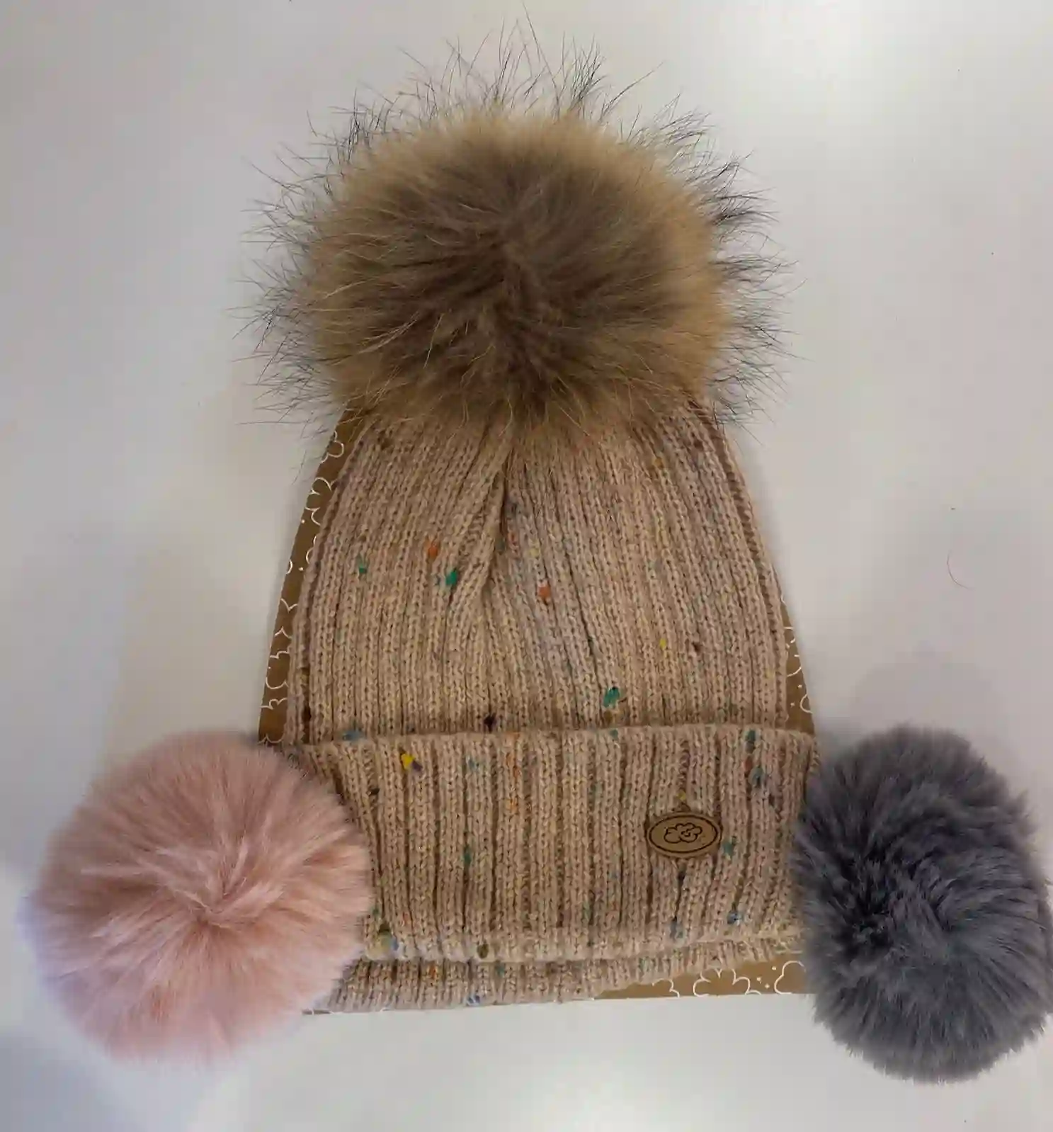 Pink hat with interchangeable pompoms