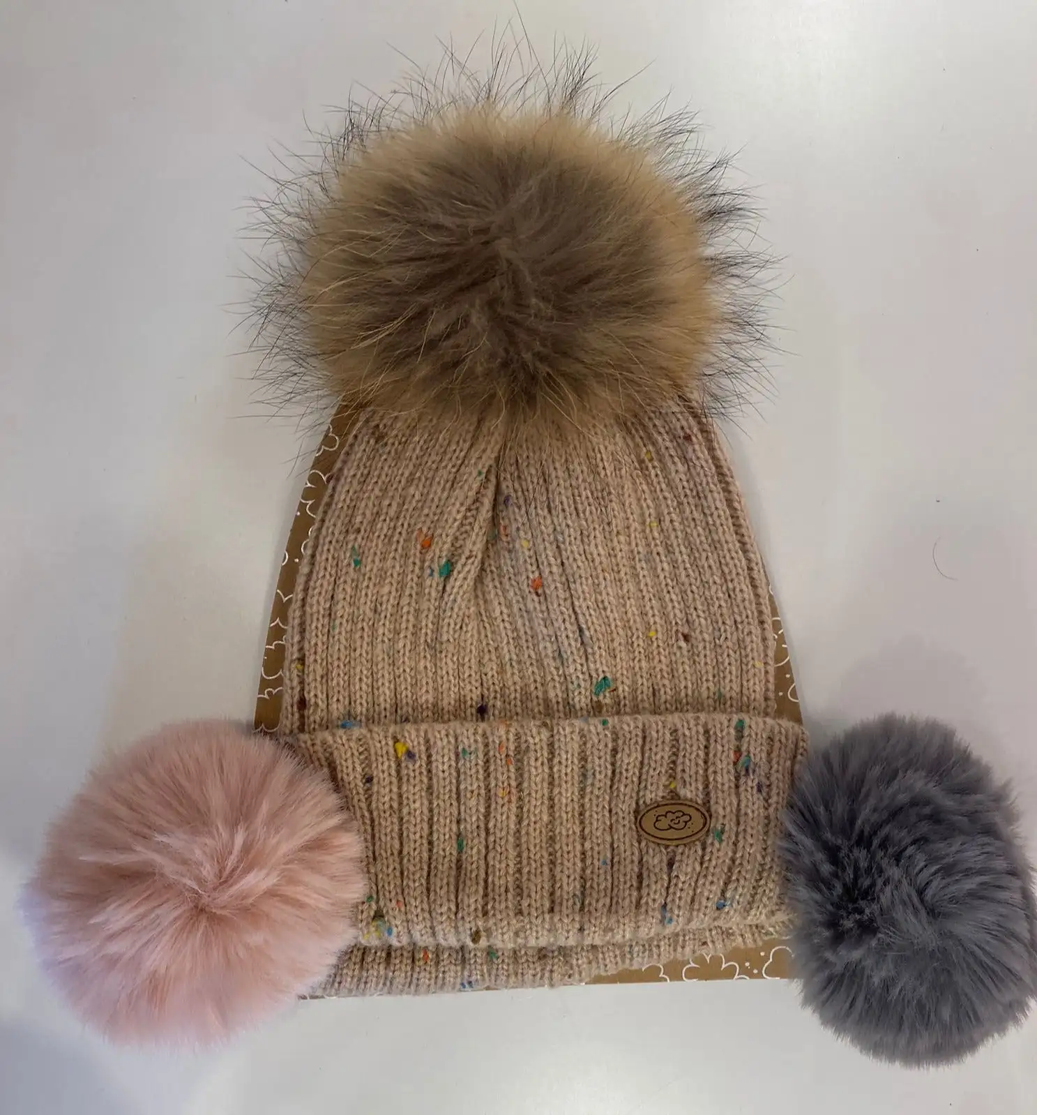 Pink hat with interchangeable pompoms
