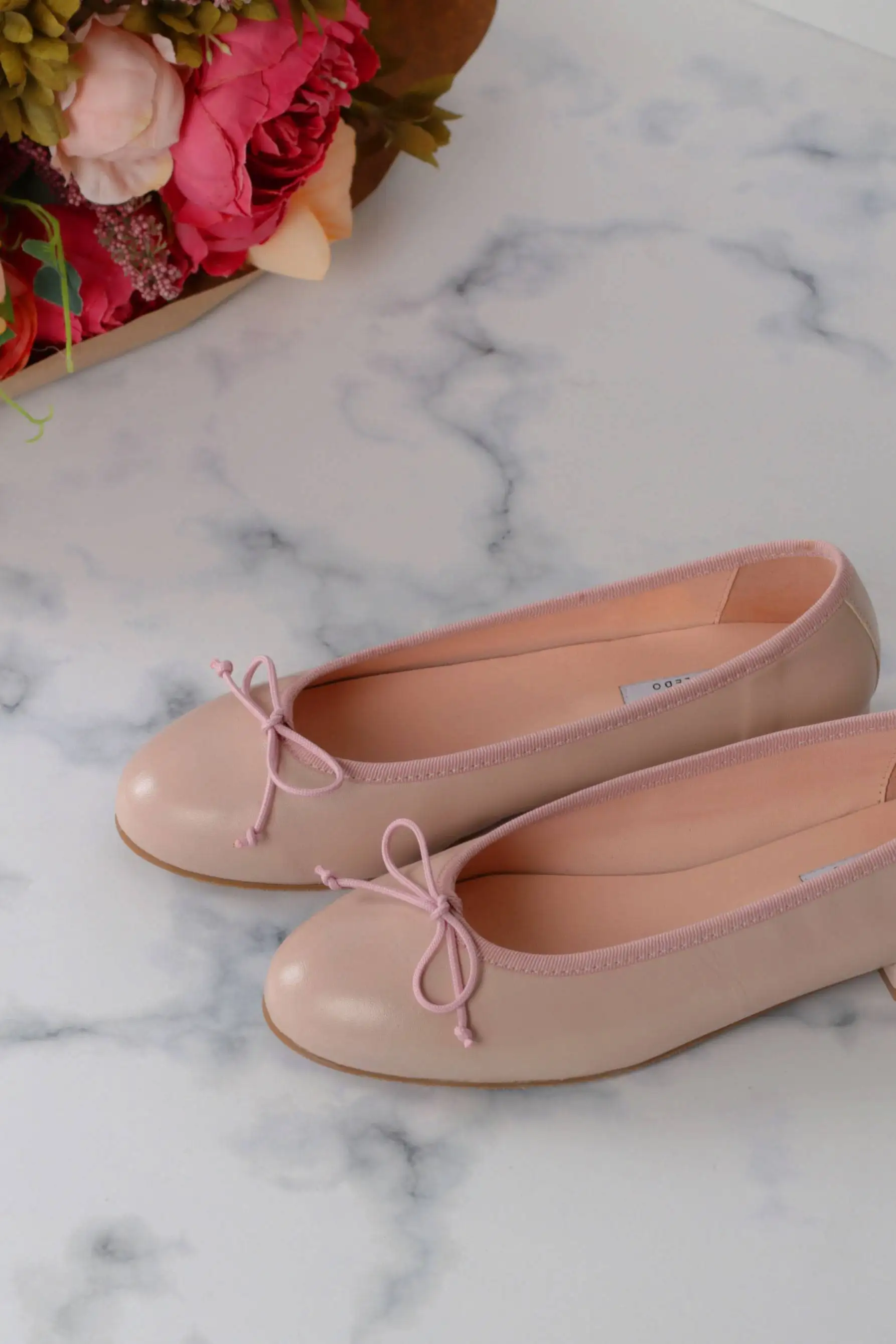 Bailarinas rosa empolvado detalle tacón bajo